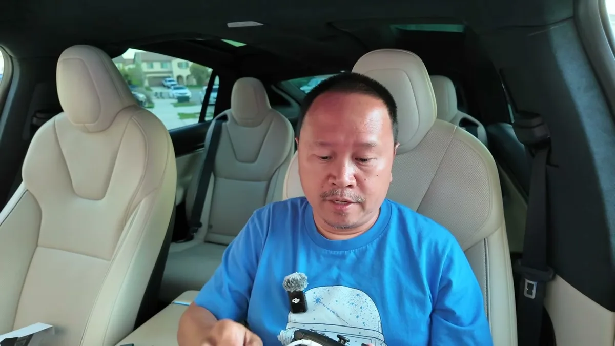 Sherwin in the Model X showing the Jowua glove box USB hub