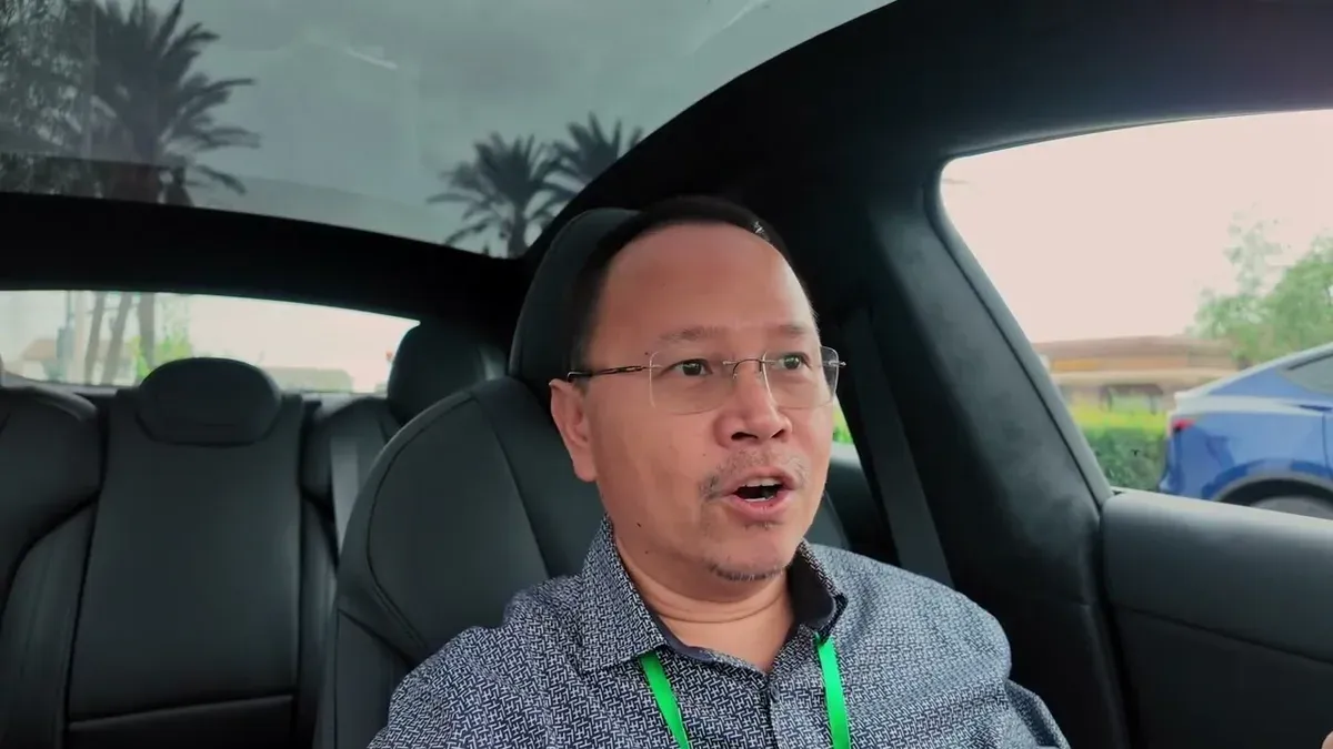 Man with glasses in driver's seat reviewing the 2026 Model S efficiency data: 226.8 Wh/mi over 138 miles.