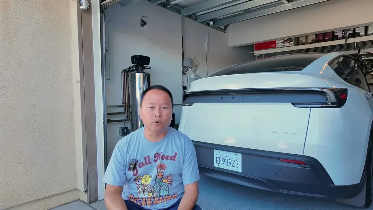 Sherwin in his garage discussing the discounts and promotions available on the Model Y Juniper