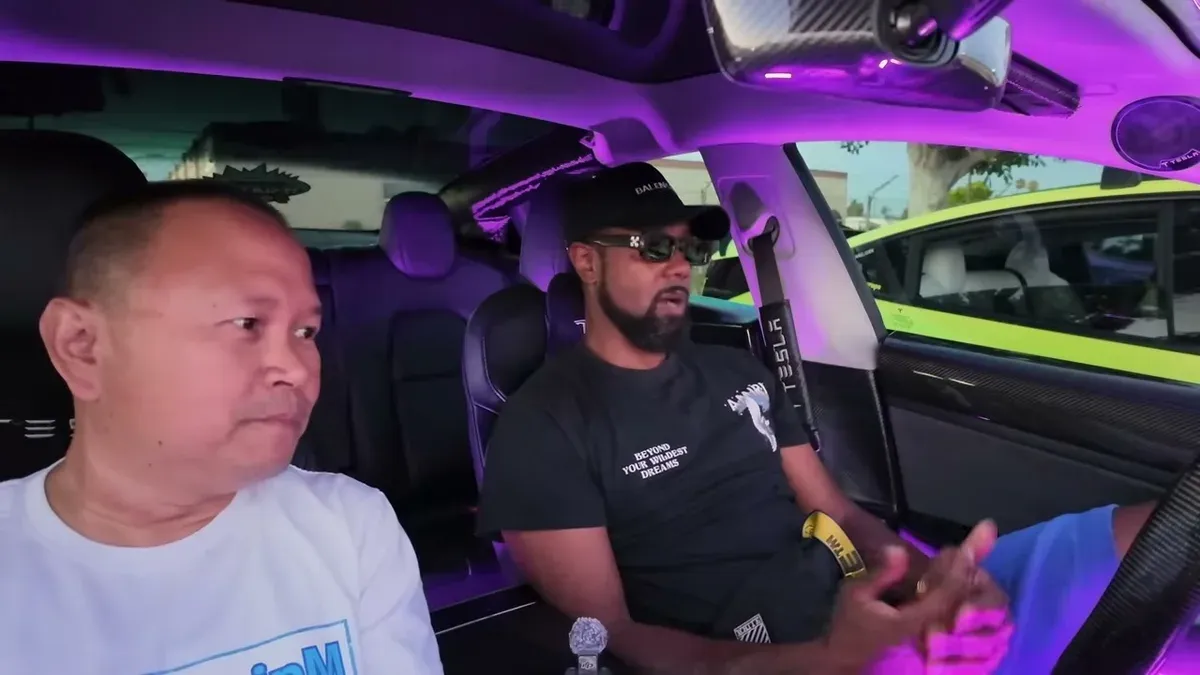 Reese and Sherwin in the Model 3 interior discussing the carbon fiber headliner and column work