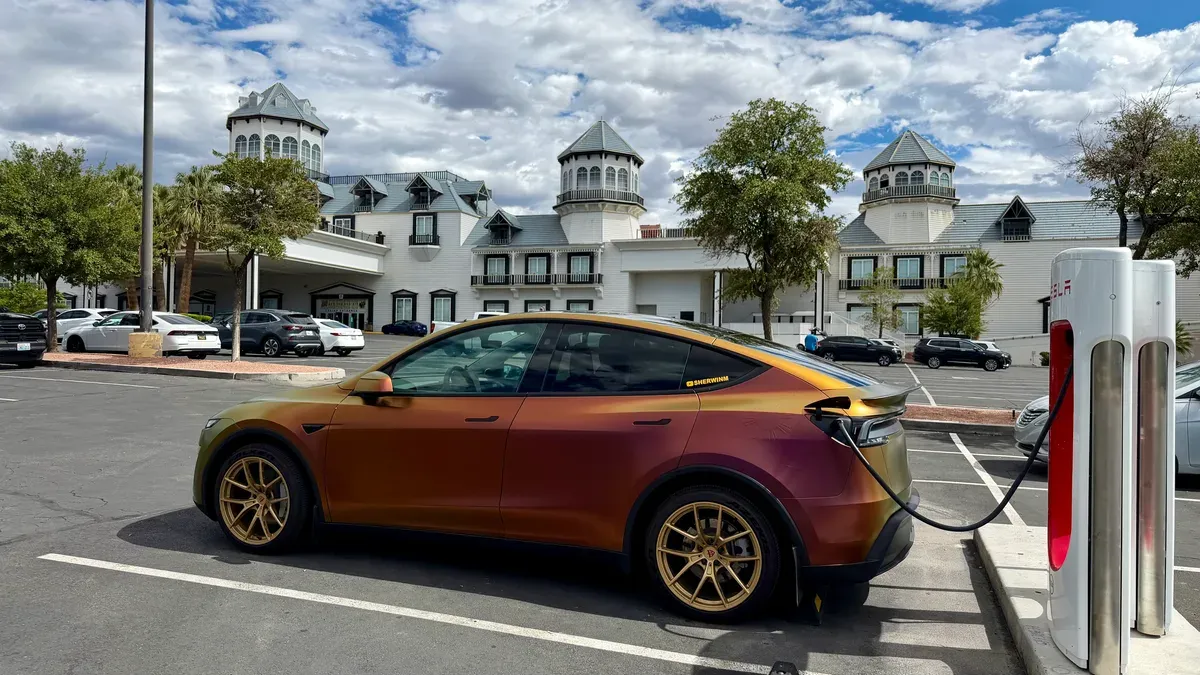 Color-shift wrapped Tesla Model Y Juniper Supercharging at Primm Nevada on the way to Las Vegas