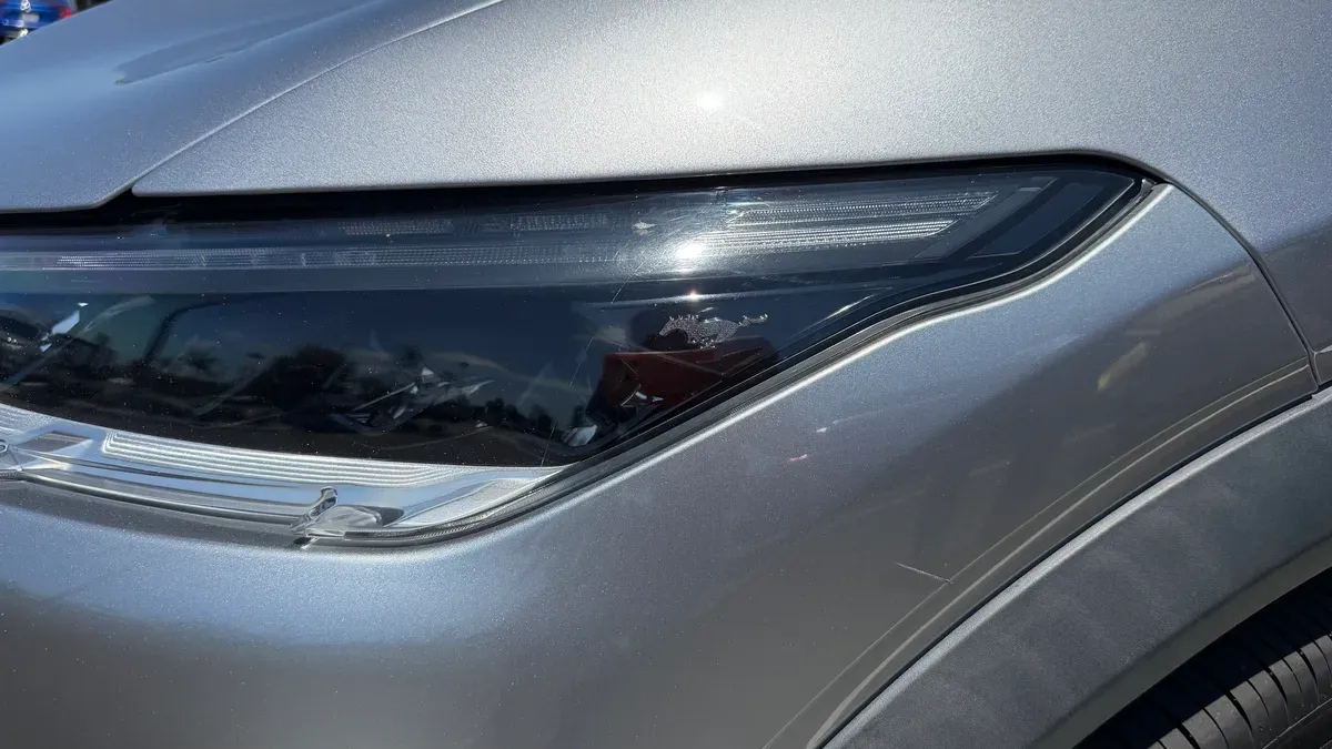 Close-up of the Mach-E LED headlight assembly on Keisha's silver Mustang