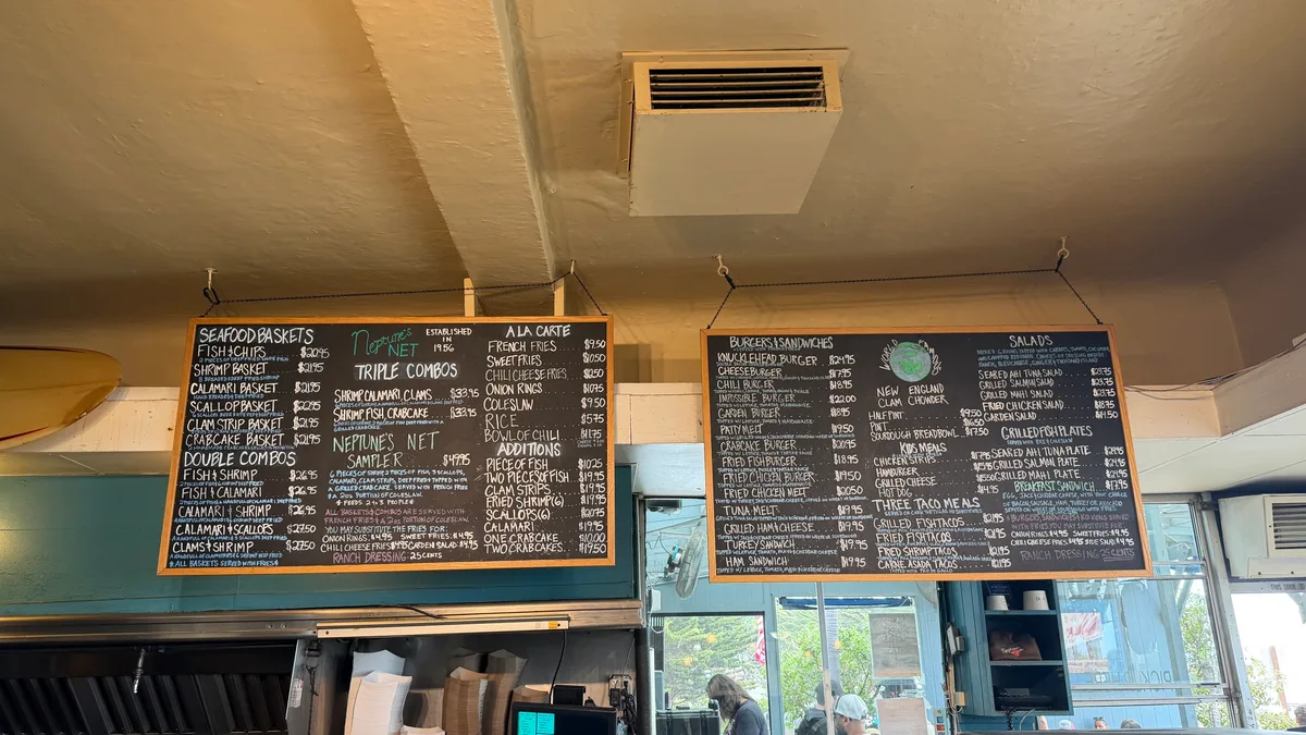 Seafood menu boards inside Neptune's Net