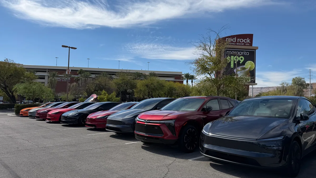 Lineup of Tesla Model S sedans, a Chevy Blazer EV and a Model Y parked outside Red Rock Casino Resort in Las Vegas