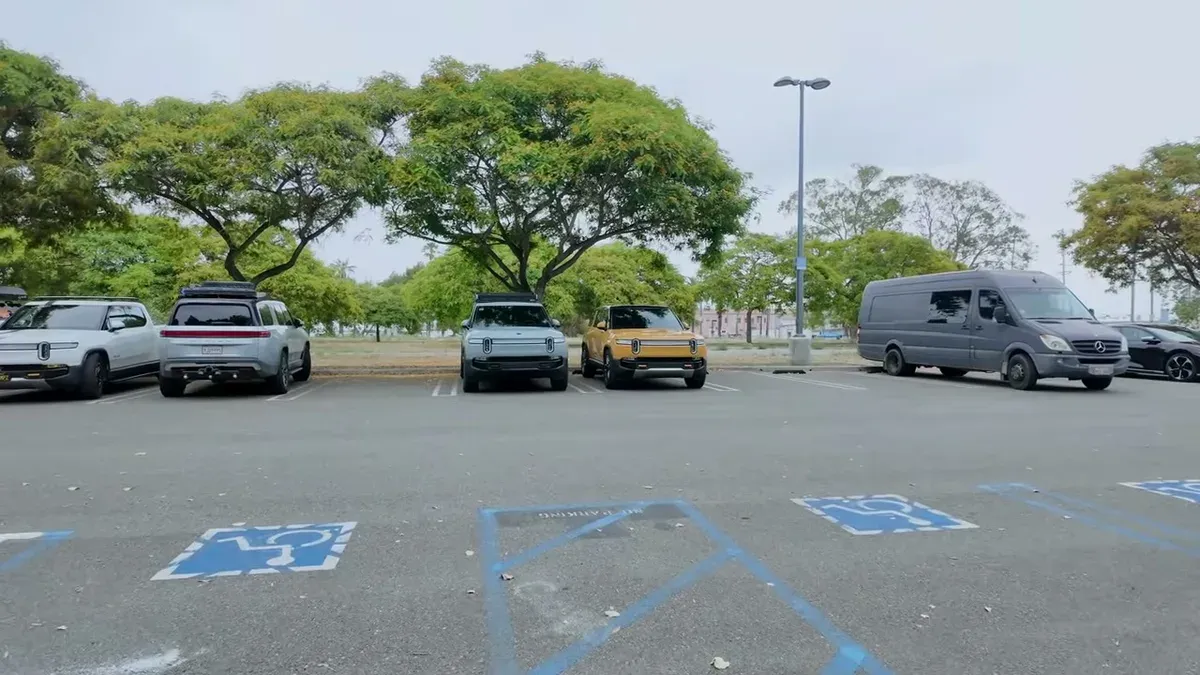 Multiple Rivian R1T and R1S EVs from SoCal clubs gathered in the parking lot