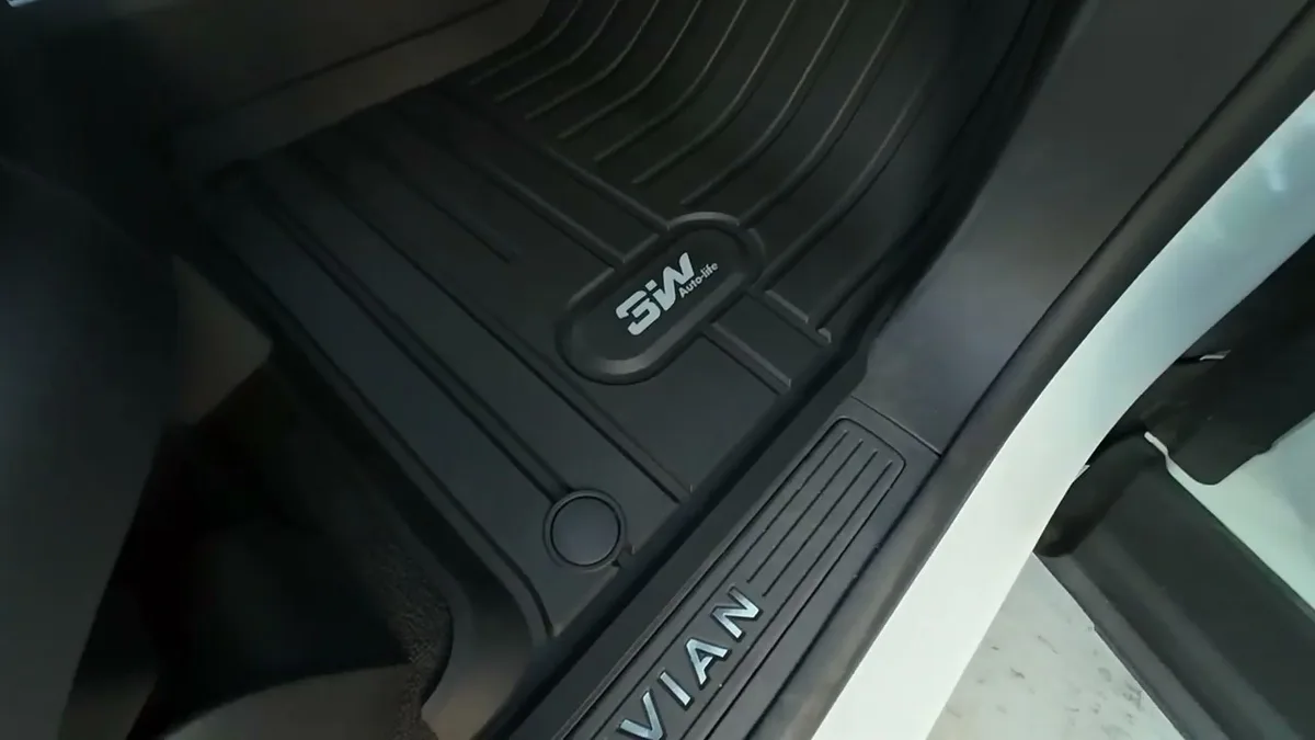 Installed 3W floor mat on Rivian R1S front passenger side showing logo and door sill coverage