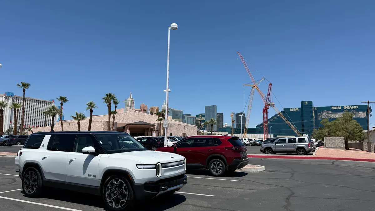 White Rivian R1S parked in a Las Vegas lot with the MGM Grand hotel sign visible in the background