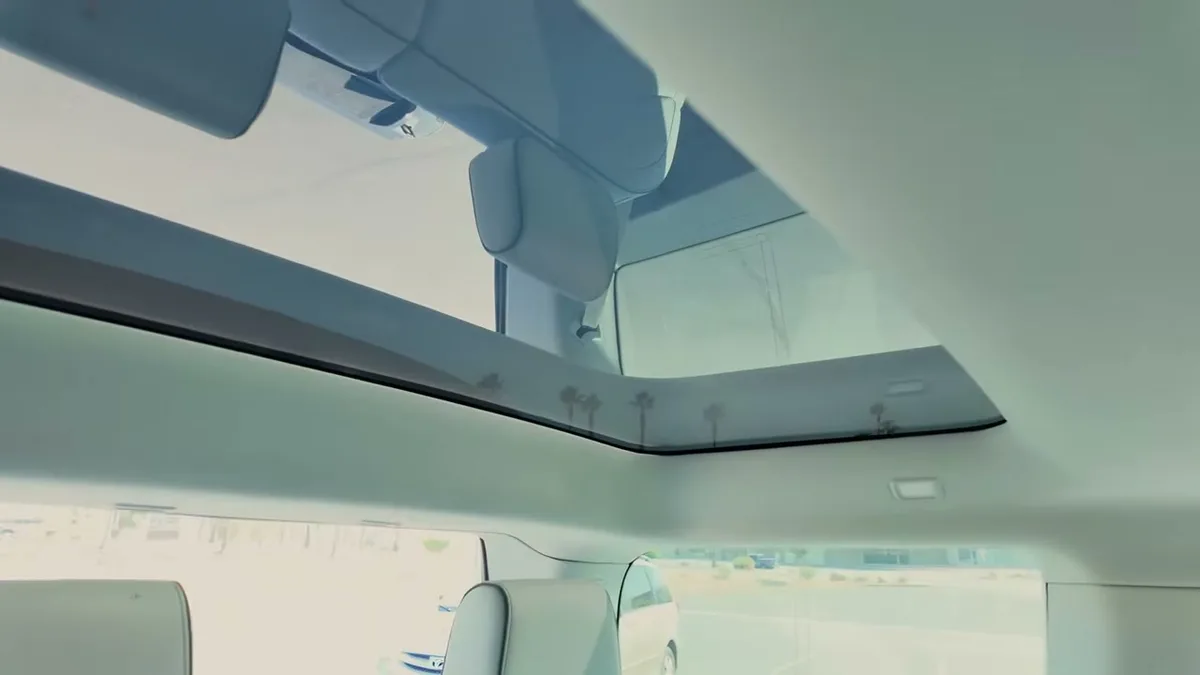 Rivian R1S panoramic glass roof uncovered, sky visible