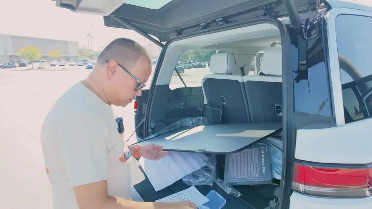 Setting up rear roof shade panel at Rivian tailgate