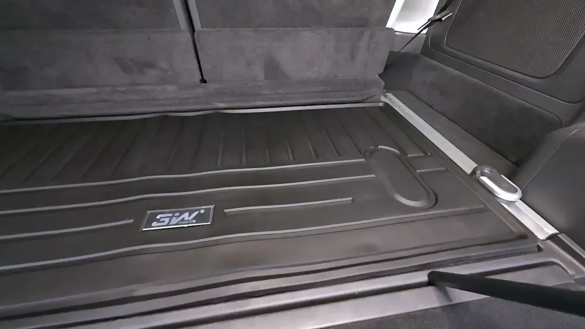 Black 3W trunk liner installed flat in Rivian R1S cargo area with third-row seats down
