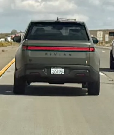 Rivian R1T truck seen from behind on the highway during the Zero Emissions Run convoy to Las Vegas
