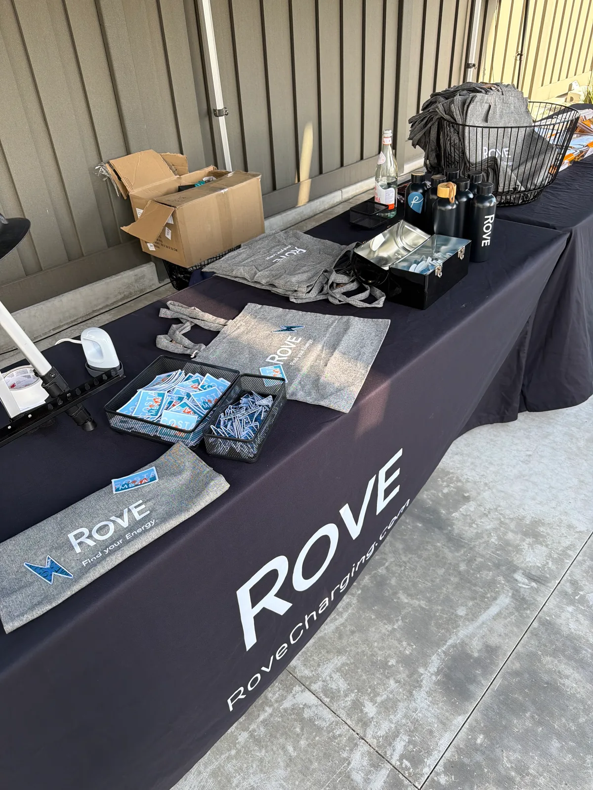 Rove branded merchandise display table at the Costa Mesa opening event.