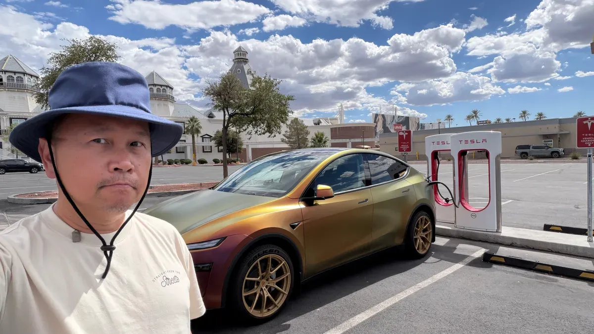 Sherwin standing next to his wrapped Model Y Juniper at the Primm Supercharger