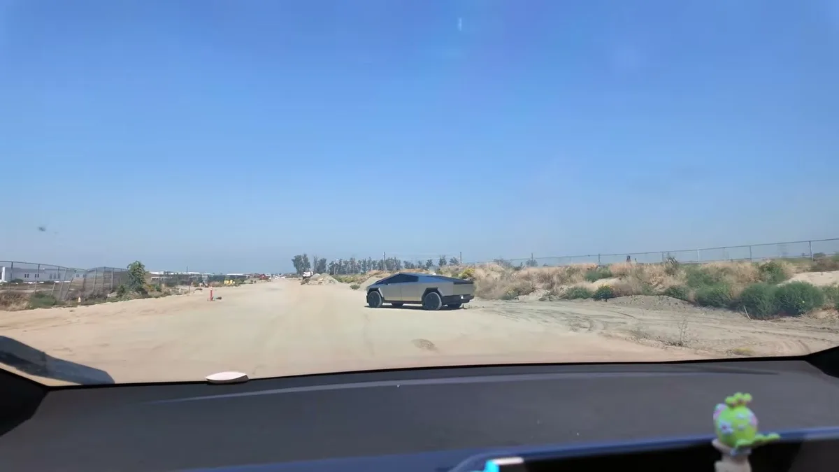 KobraToldYa's silver Cybertruck parked on a dirt road