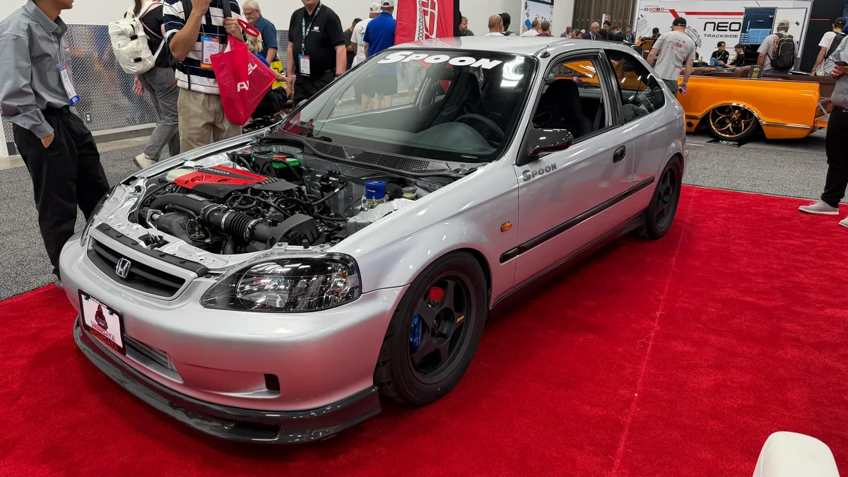 Silver Honda Civic hatchback with Spoon Sports livery on display at SEMA 2025