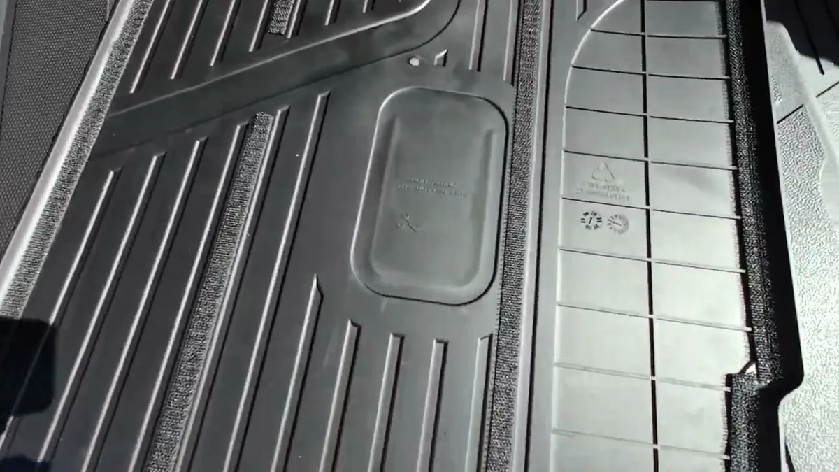 Close-up of black 3W rear seat protector with textured surface and 3W logo