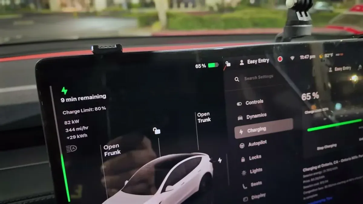 Tesla infotainment screen showing 65% charge, 9 minutes remaining, and a white Model 3 graphic.
