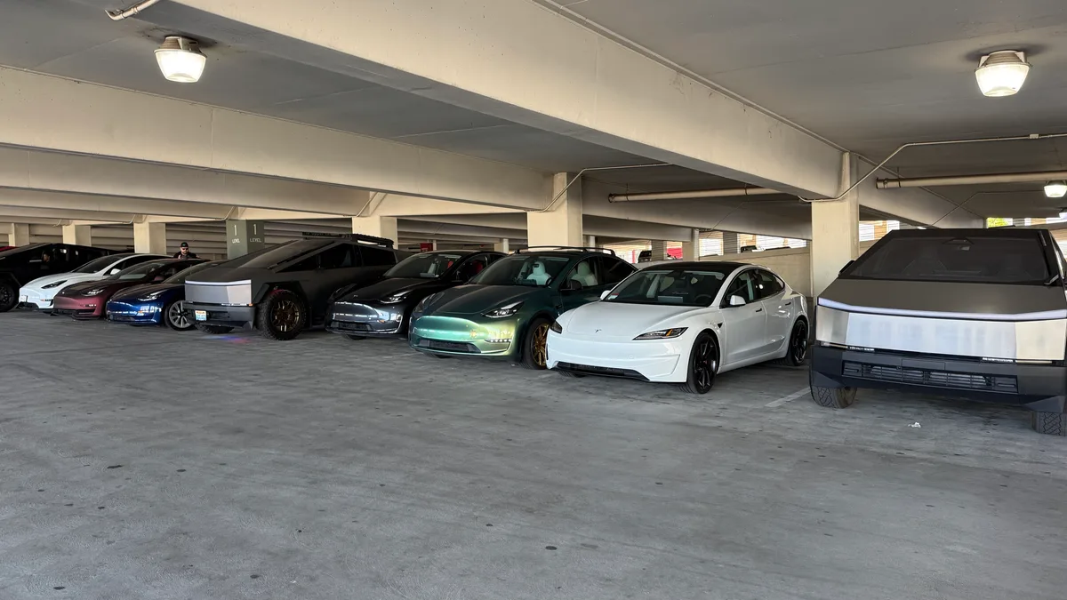 Diverse Tesla lineup including Cybertrucks, Model 3s, and Model Ys at the Inland Center Mall Supercharger in San Bernardino