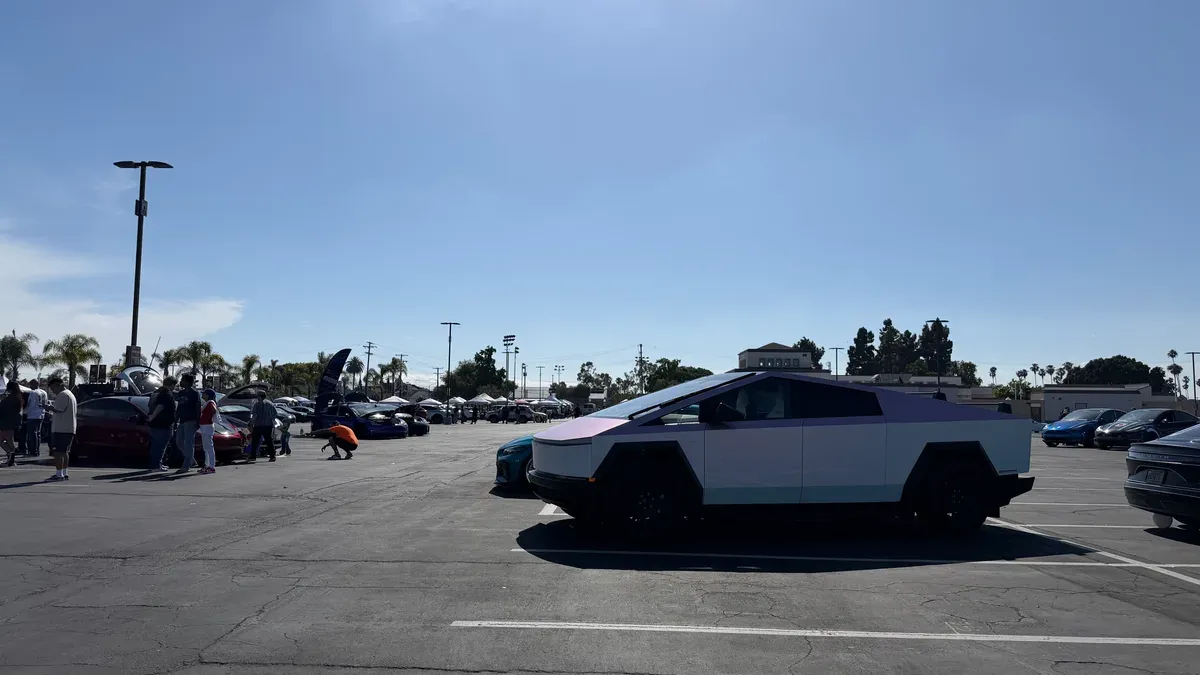 Tesla Cybertruck with a white and light purple two-tone wrap at EV Fest 2026 in Long Beach.