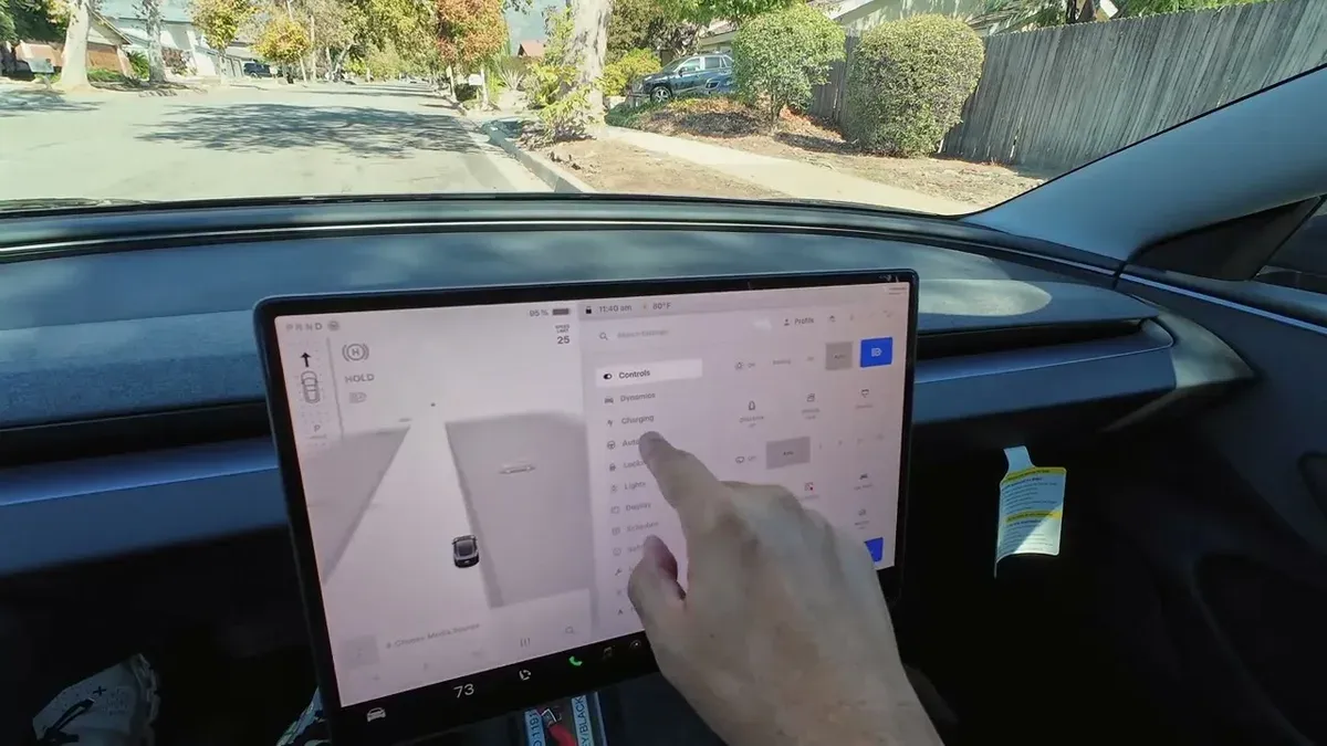 Close-up of the Tesla touchscreen showing FSD v13.2.9 controls and map view