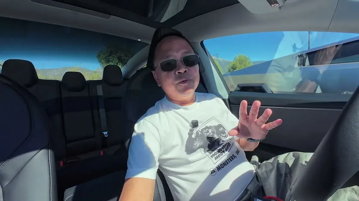 Sherwin in the driver's seat demonstrating the on-screen seat adjustment controls