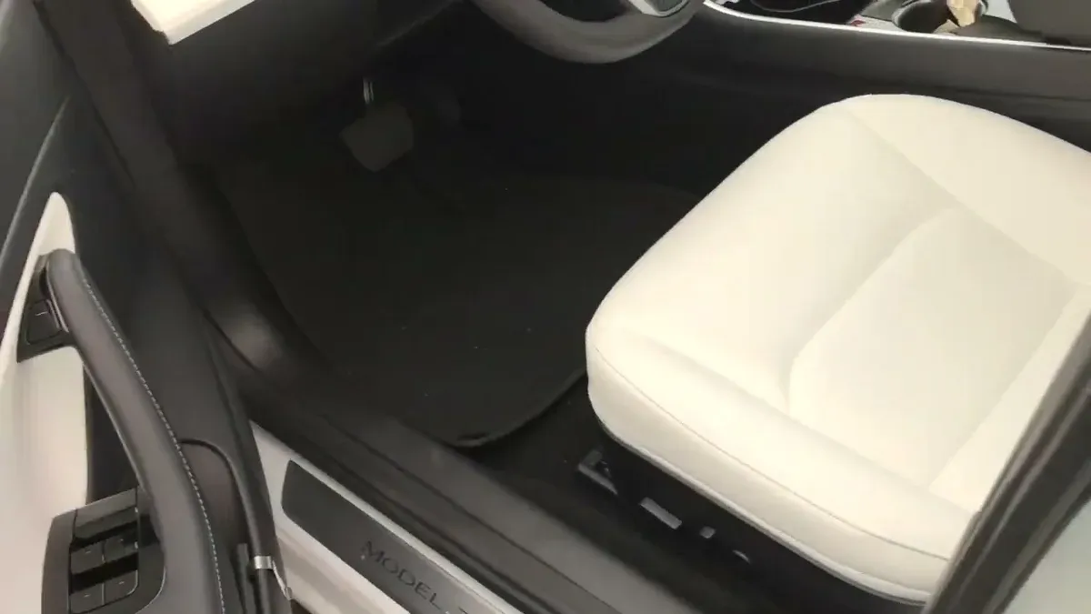 Tesla Model 3 white interior, driver's seat and door panel