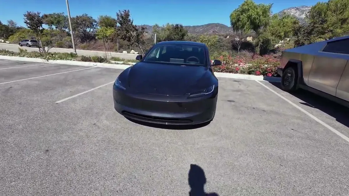 Model 3 Standard parked head-on next to the Cybertruck RWD in a sunny parking lot