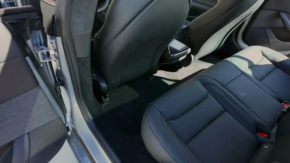 Spacious black leather rear seats of the 2026 Tesla Model S with panoramic glass roof overhead.