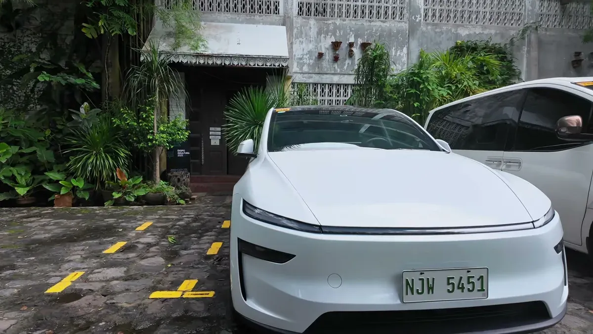 Front view of a white Tesla Model Y Juniper parked on a cobblestone driveway in the Philippines