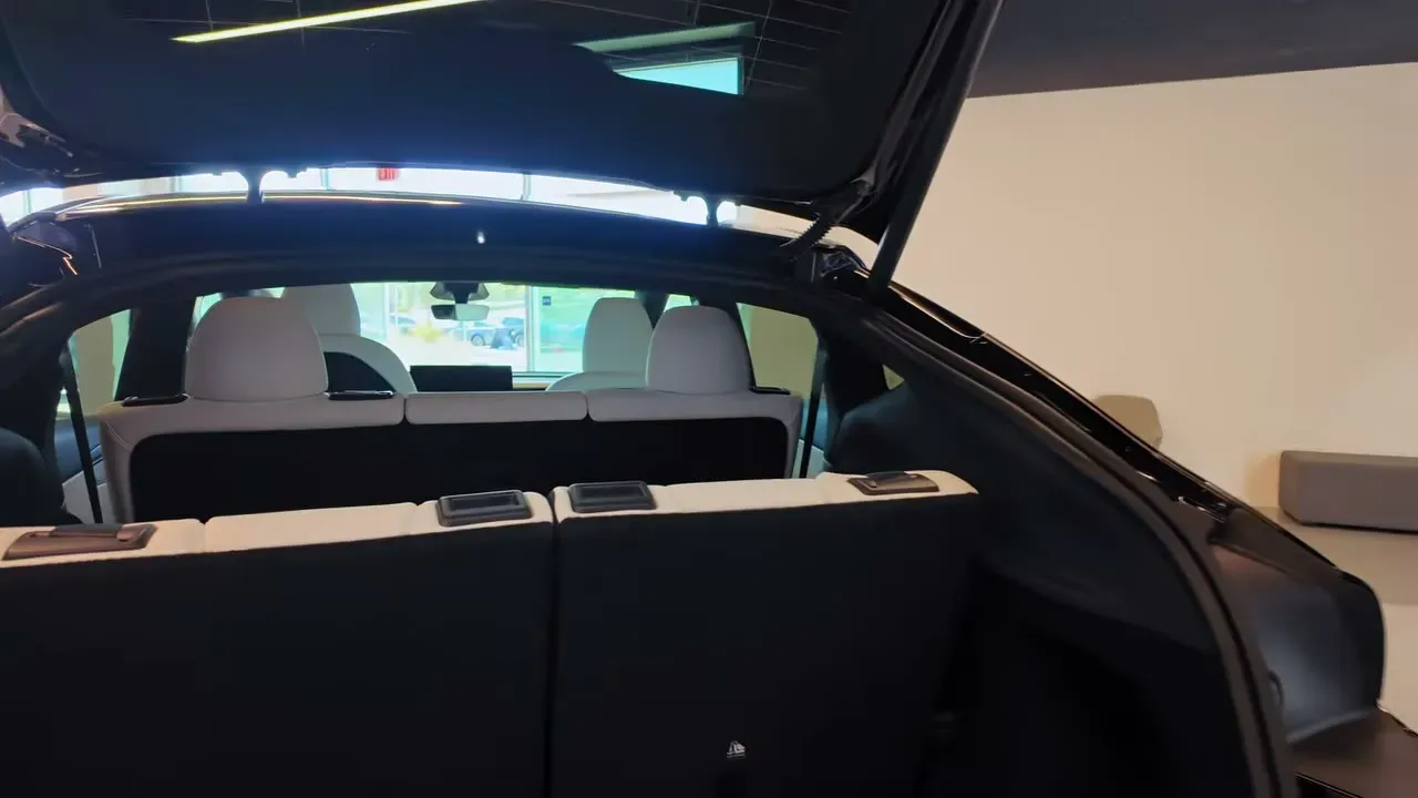 Third row of the Tesla Model Y Juniper 7-seater folded flat with the second row visible, hatch open, in the Montebello showroom.