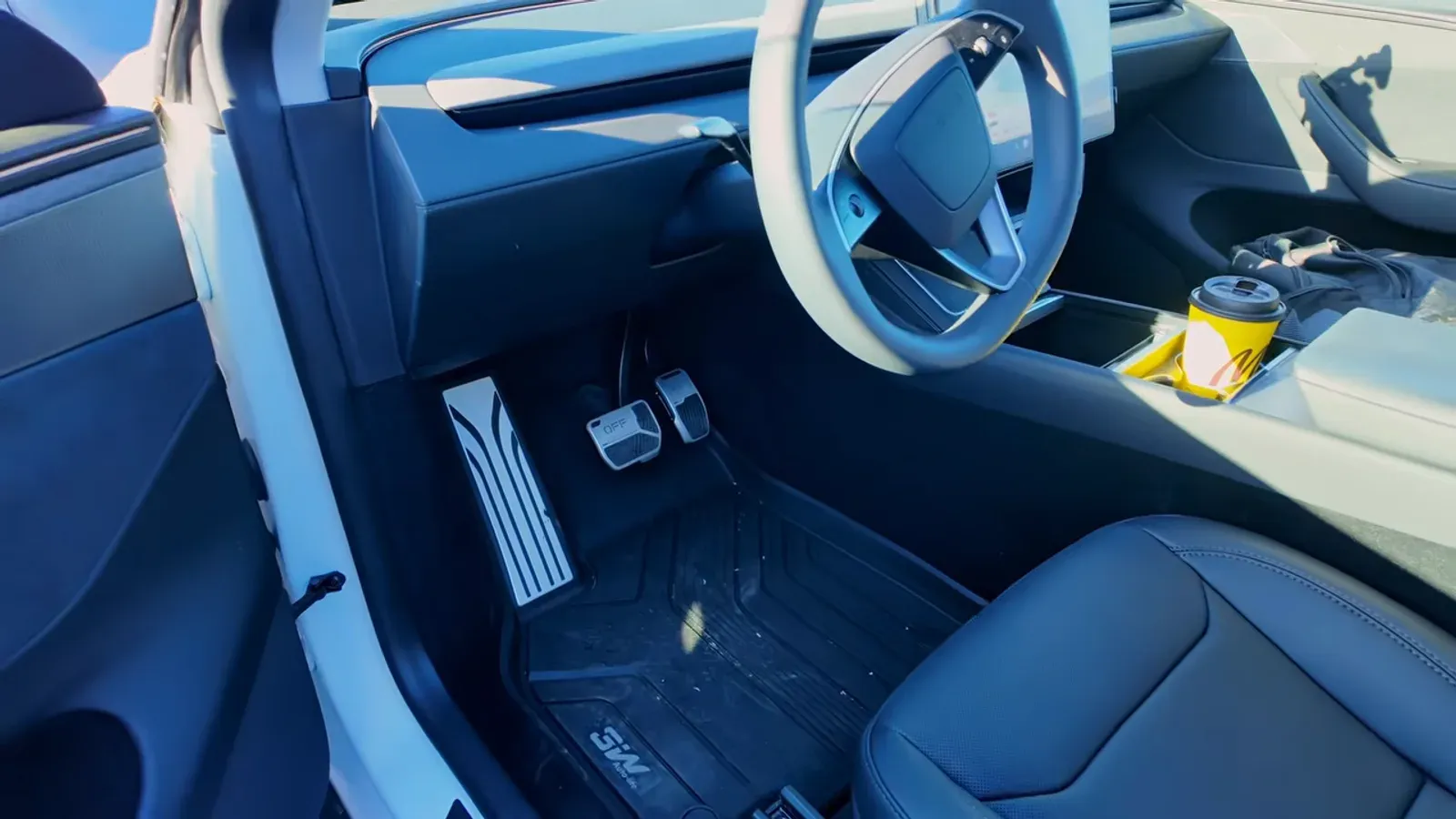 New black driver seat in a Tesla Model Y Juniper after the service center replaced the whole seat assembly