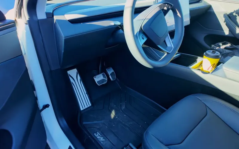 New black driver seat in a Tesla Model Y Juniper after the service center replaced the whole seat assembly