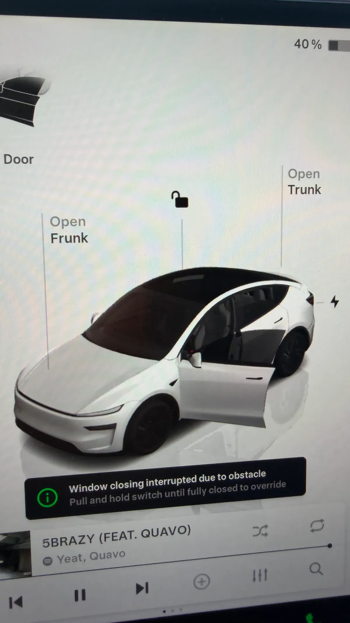 Tesla Model Y infotainment screen showing open door warning and window obstacle alert