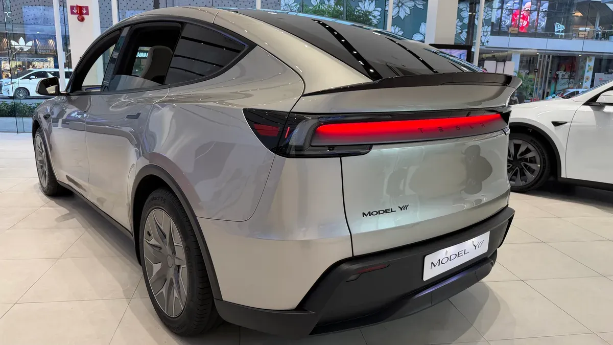 Rear three-quarter view of the Cosmic Silver Tesla Model YL