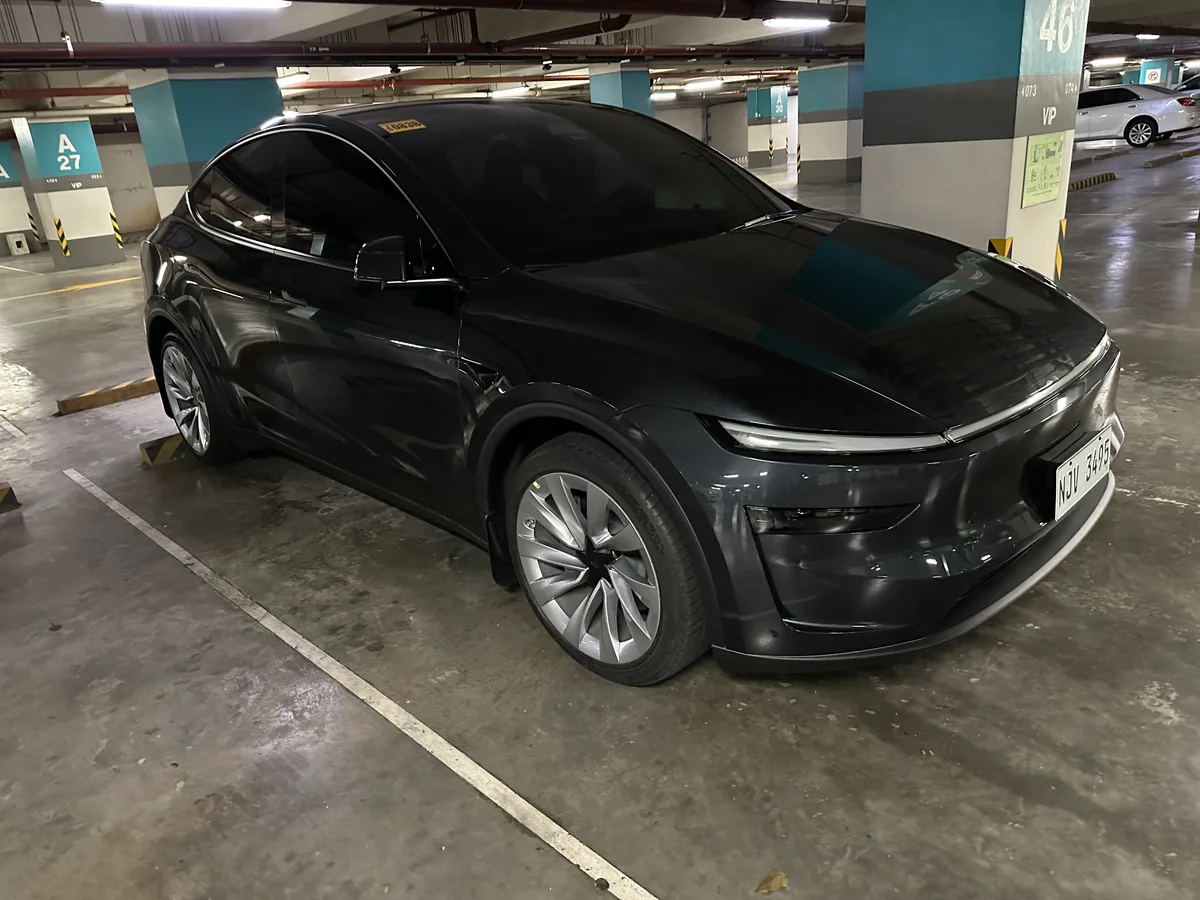 Front quarter view of a Stealth Gray Tesla Model Y parked in an underground garage in the Philippines