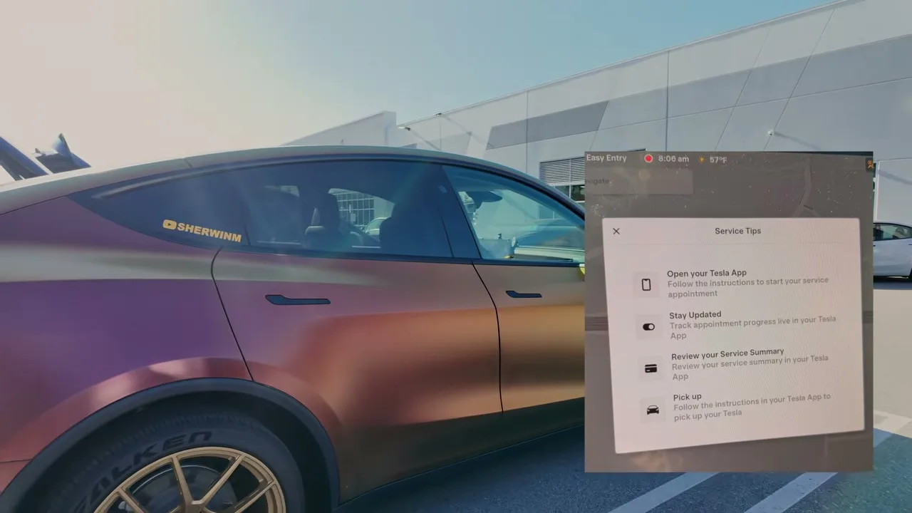 Tesla Model Y profile view at service center with the in-car service tips screen showing