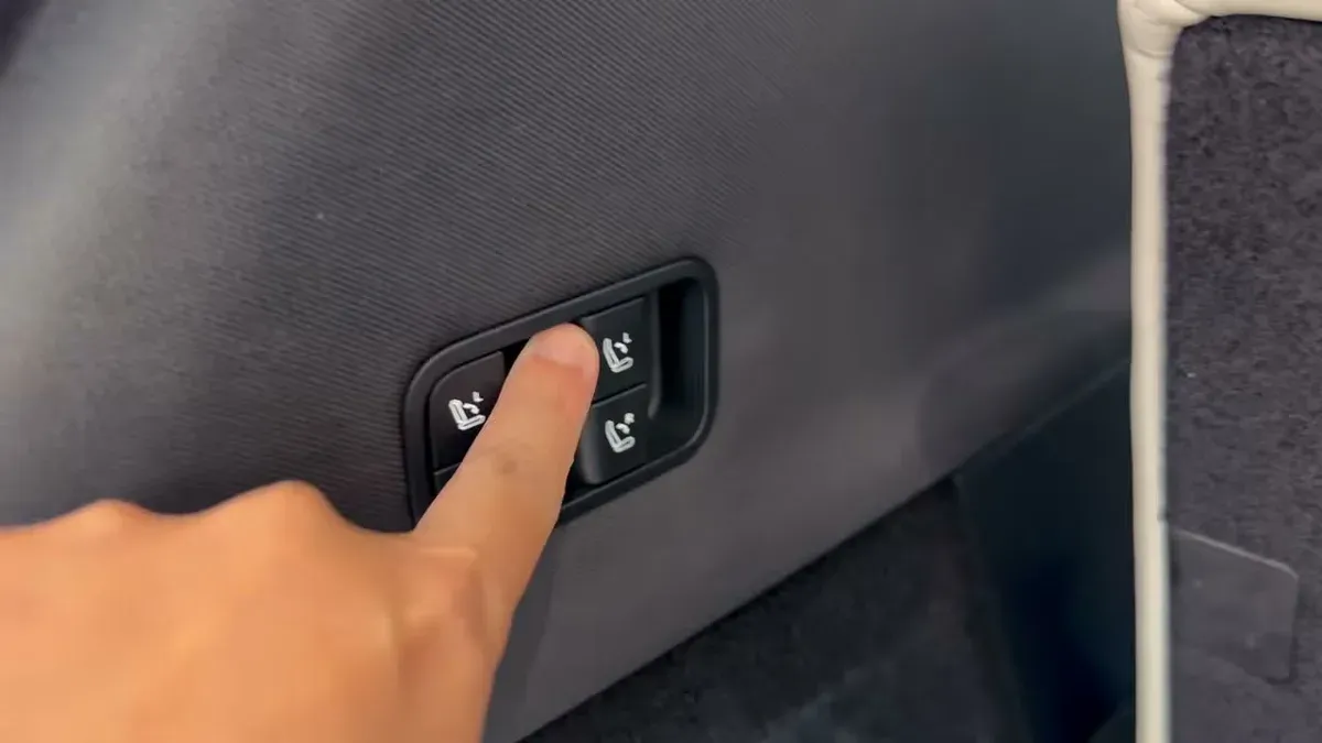 Tesla Model YL power-folding seat controls in the trunk area
