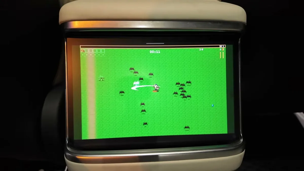 Tesla Model X rear screen showing a pixel-art style game being played