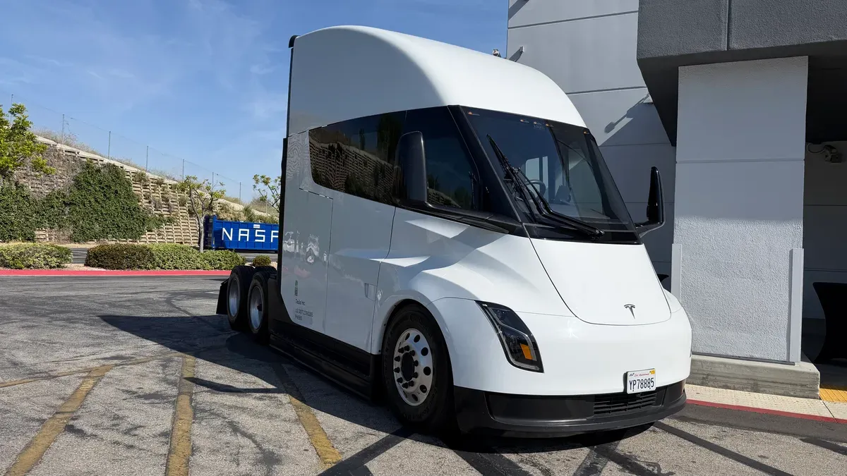 Tesla Semi parked next to a "NASA Inc" container at the Montebello event.