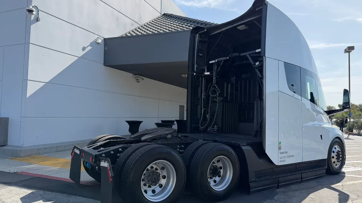 Rear-side view of the Tesla Semi showing the fifth wheel and exposed drive components.