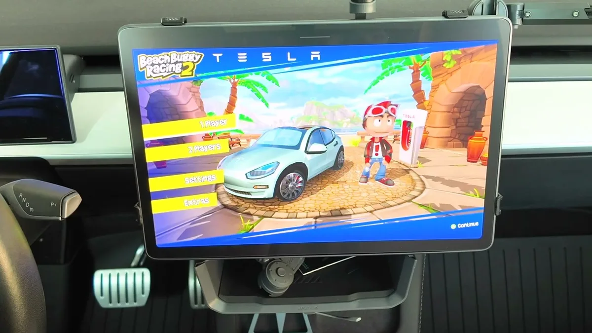 Tesla touchscreen showing Beach Buggy Racing 2 title screen with 1 Player and 2 Players options