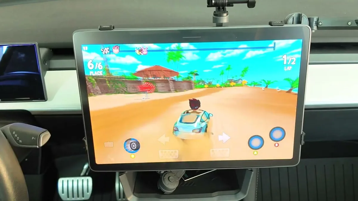 Tesla touchscreen showing Beach Buggy Racing 2 gameplay from the driver perspective