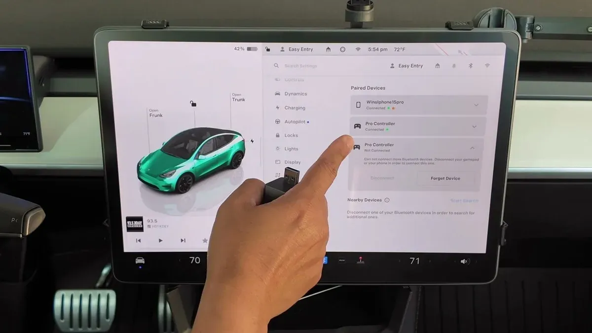 Tesla Model Y touchscreen showing Bluetooth settings with two Pro Controllers listed — one connected via Bluetooth, one via USB