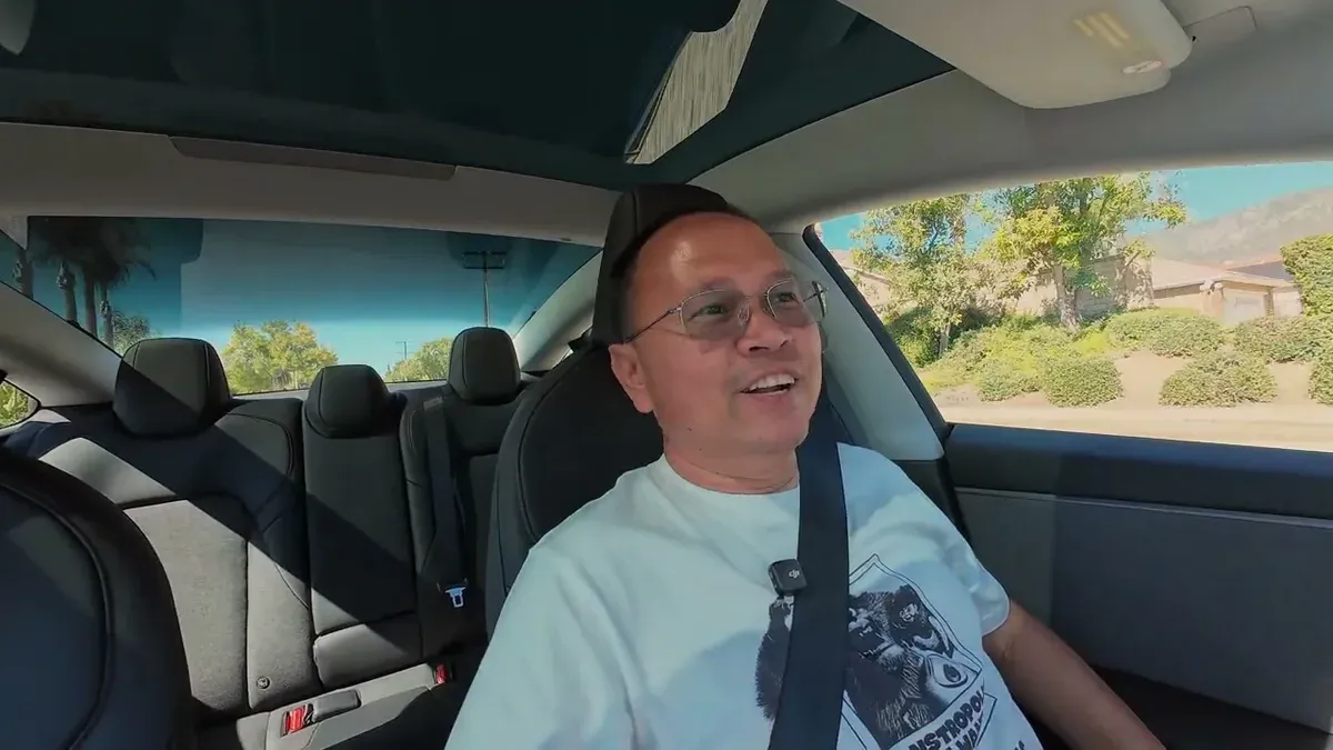 Tesla touchscreen showing 'A Milli' by Lil Wayne playing during the sound system test