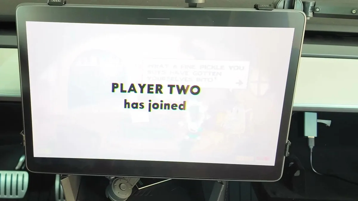 Tesla touchscreen showing 'PLAYER TWO has joined' in Castle Doombad