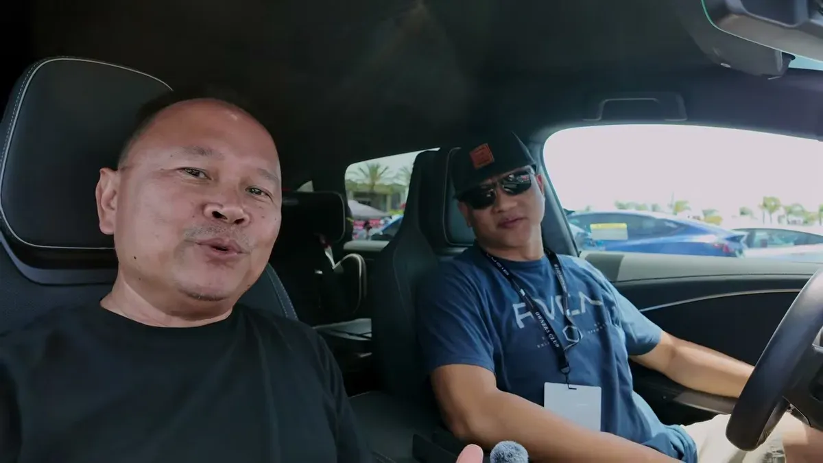 Two men seated inside the Lucid Gravity at EV Fest 2026, talking about the car's features.