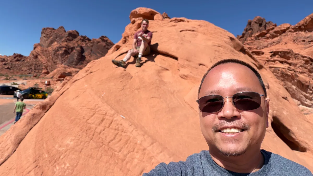 Sherwin standing in front of the red rock formations at Valley of Fire State Park, Nevada