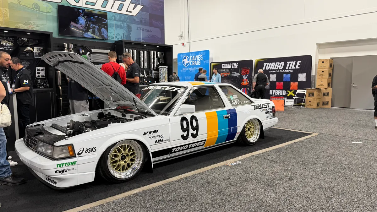 Vintage white racing coupe with number 99 livery on display at SEMA 2025