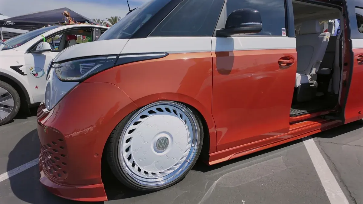 Low-angle view of the custom VW ID. Buzz front wheel and lowered air suspension