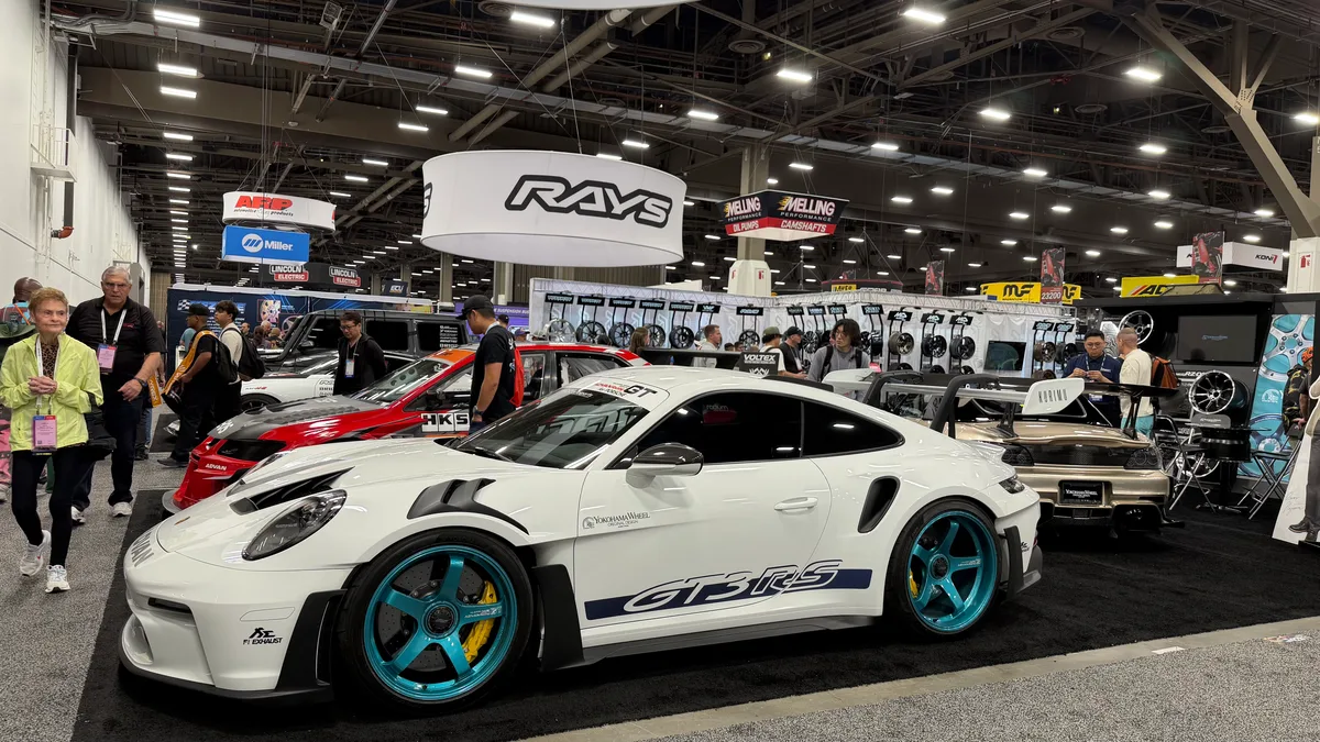 White Porsche 911 GT3RS with teal wheels on display at SEMA 2025